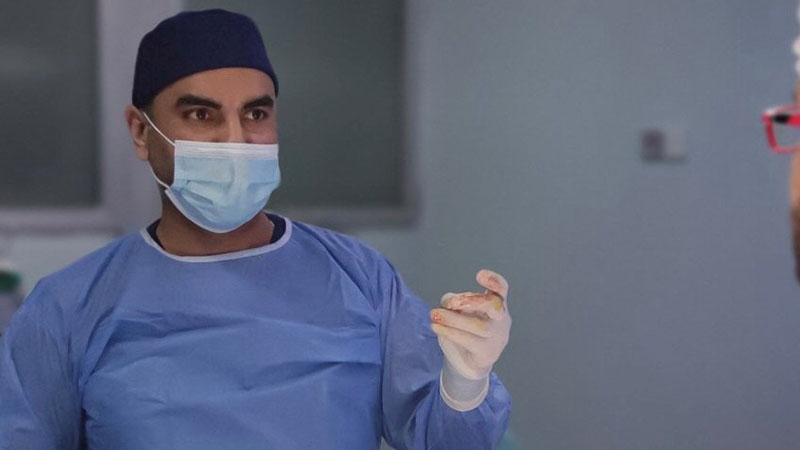 Image of alumnus Mahood Hardan in surgical scrubs